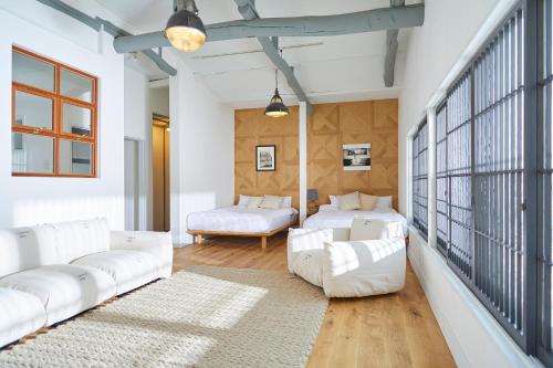 a living room with white furniture and a large window at MORITO Funny house in Hayama