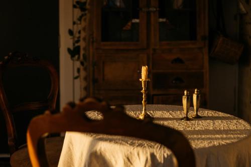 a table with two candles on top of it at Ocean beach front, 3 Capes Cottage. in Eaglehawk Neck
