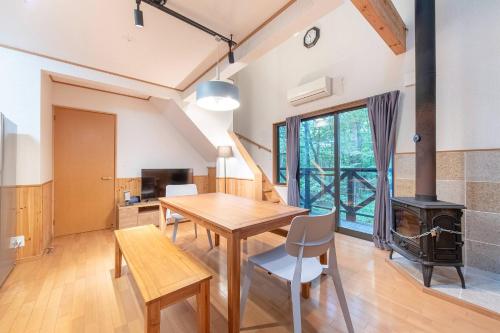 a dining room with a table and a wood stove at S-villa Nasu 7th in Nasu
