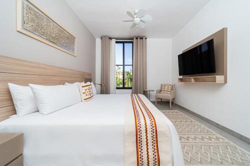 a hotel room with a bed and a tv at Krystal Grand Residences & Villas San Miguel de Allende in San Miguel de Allende