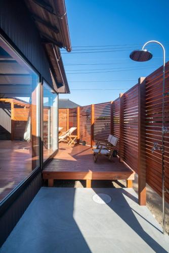 a deck with a bench on the side of a building at THE SECOND Kujukuri Beach House in Kujukuri