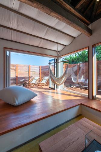 a room with a bed and a hammock on a deck at THE SECOND Kujukuri Beach House in Kujukuri