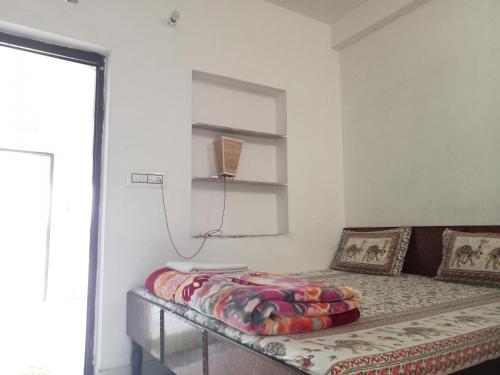 a bed in a room with a window and a bed at Cocoon Auberge in Jaipur