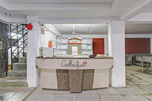 a kitchen with a counter in the middle of a room at Super Collection O Fortune Inn in Pune