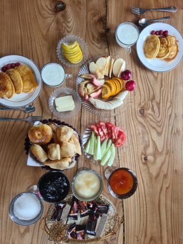 a wooden table with plates of food on it at Кереге-Таш in Karakol