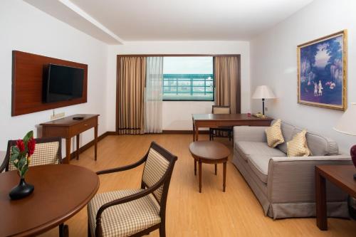 a living room with a couch and a table at Ramada by Wyndham D MA Bangkok in Bangkok