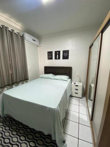 a bedroom with a large white bed and a tiled floor at Apto refúgio 101 em São Luís/MA (inteiro) in São Luís