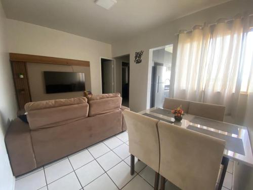 a living room with a couch and a table at Apto refúgio 101 em São Luís/MA (inteiro) in São Luís