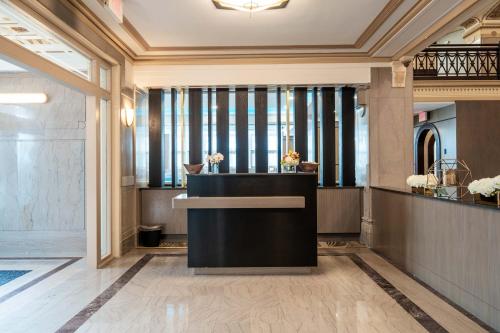 a lobby with a reception desk in a building at Sandman Signature Fort Worth Downtown Hotel in Fort Worth