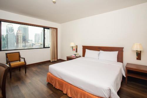 a hotel room with a large bed and a large window at Ramada by Wyndham D MA Bangkok in Bangkok