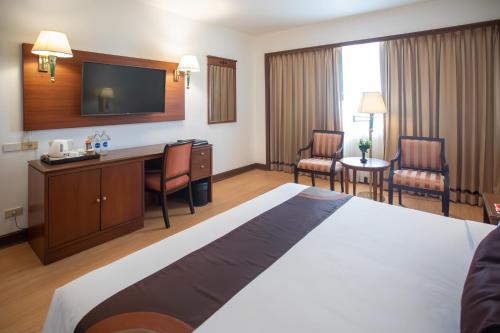 a hotel room with a large bed and a television at Ramada by Wyndham D MA Bangkok in Bangkok