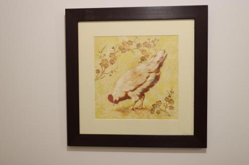 a framed picture of a bird eating grass at Melbourne holiday house for 15 peoples in Sanctuary Lake in Point Cook