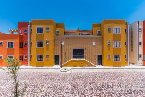 a group of buildings in a city with a cobicked street at Krystal Grand Residences & Villas San Miguel de Allende in San Miguel de Allende