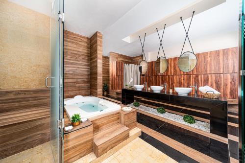 a bathroom with a tub and two sinks at Krystal Grand Residences & Villas San Miguel de Allende in San Miguel de Allende