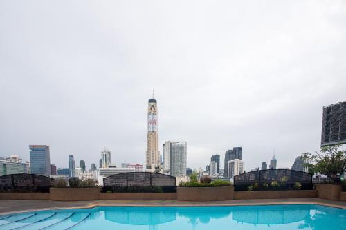 a swimming pool with a city skyline in the background at Ramada by Wyndham D MA Bangkok in Bangkok