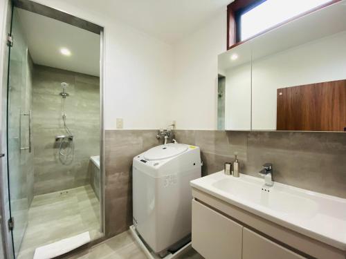 a bathroom with a sink and a toilet and a shower at Bond Chalet Hakuba - Vacation STAY 76698v in Hakuba