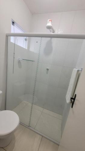 a glass shower in a bathroom with a toilet at Aquarela do Sertão in Piranhas