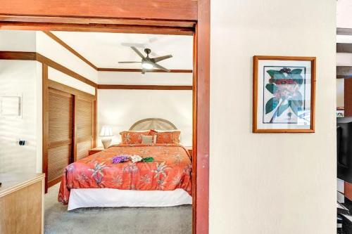 a bedroom with a bed and a ceiling fan at Kiahuna Plantation in Koloa