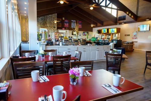a restaurant with tables and chairs and a counter at Hotel Cape Cod in Falmouth