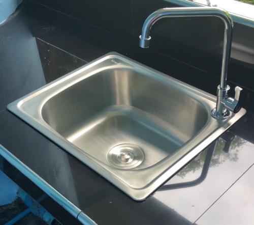 a stainless steel sink with a faucet in a kitchen at Jamie's home with 2 bedrooms, can accommodate 6 guests in Ko Samed