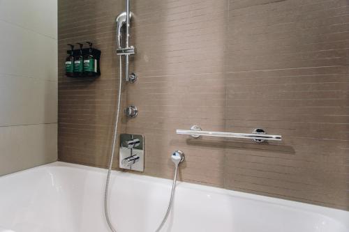 a shower in a bathroom with a tub at Crowne Plaza Belgrade by IHG in Belgrade