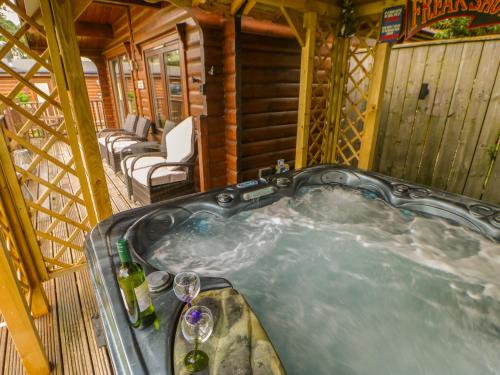 una bañera de hidromasaje en una cabaña de madera en Cornfield Lodge, en Northallerton