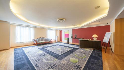 a living room with a couch and a table at New Otani Inn Sapporo in Sapporo