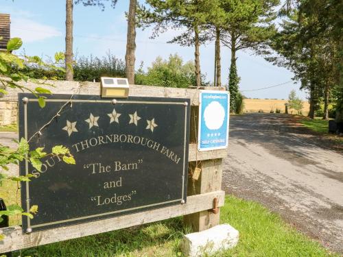 a sign for thebinhood farm with a dirt road at The Barn in Northallerton