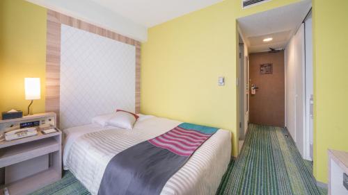 a hotel room with a bed and a hallway at New Otani Inn Sapporo in Sapporo