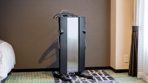 a refrigerator in the corner of a room at New Otani Inn Sapporo in Sapporo