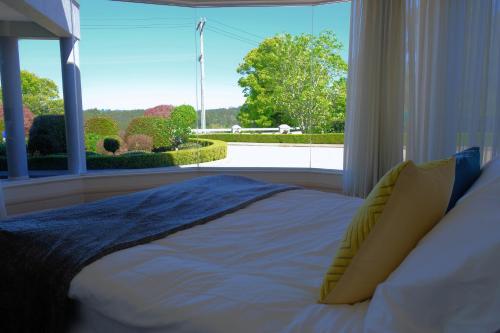uma cama num quarto com uma grande janela em Kellyville Luxury 5 Br House Quiet & Spacious em Kellyville