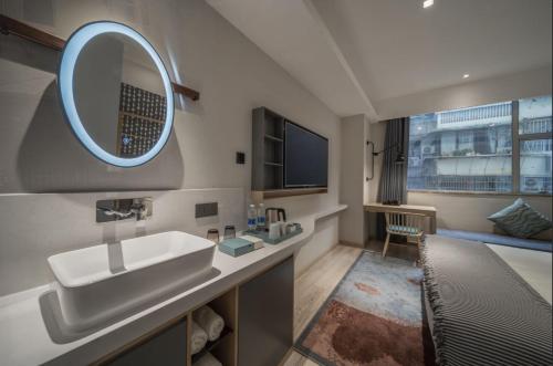 a bathroom with a sink and a mirror at CityNote Hotel Guangzhou Beijing Road Provincial People's Hospital in Guangzhou