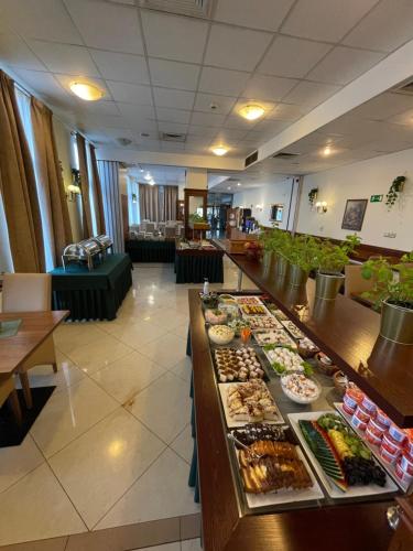 a buffet line with many different types of food at Hotel Great Polonia Conrad Kraków in Kraków