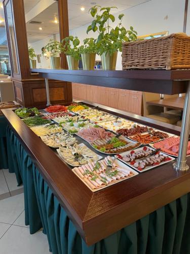 a buffet table with many different types of food at Hotel Great Polonia Conrad Kraków in Kraków