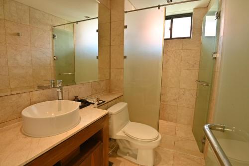 a bathroom with a sink and a toilet and a shower at Pool Villas at Danang Beach with Private Pool in Danang