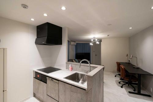 a kitchen with a sink and a counter top at Bonheur Akasaka in Tokyo