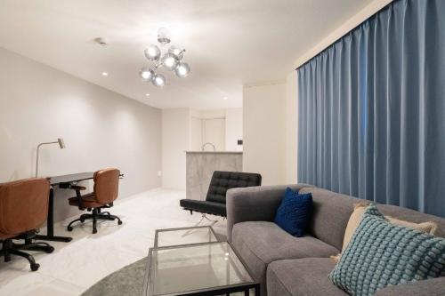 a living room with a couch and a table at Bonheur Akasaka in Tokyo