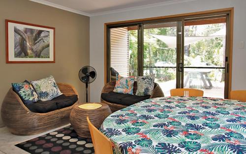 a living room with a table and chairs and a room with a table at AMITY BEACH BUNGALOW in Amity Point