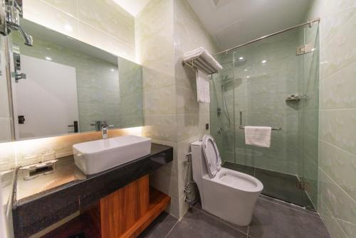 a bathroom with a sink and a toilet and a shower at Legend Hotel and Resort in Sihanoukville