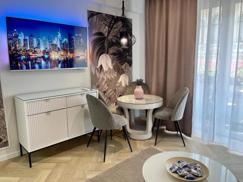uma sala de estar com mesa e cadeiras em Jeny Boutique Apartment em Târgu-Mureş