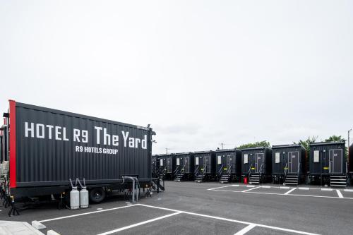 a row of trailers parked in a parking lot at HOTEL R9 The Yard Hitachinakaichige in Hitachinaka