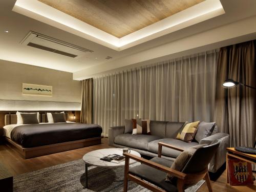 a living room with a bed and a couch at HIDEOUT in Kyoto