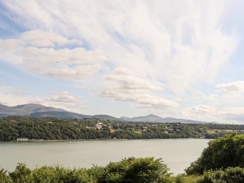 a view of a lake with mountains in the background at Dolwyn in Menai Bridge