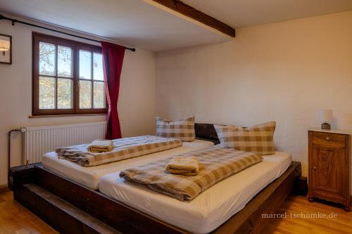 two beds sitting next to each other in a bedroom at Wohnen auf der Ritterburg in Haßmersheim