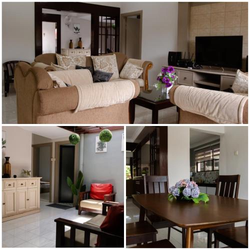 a living room with a couch and a table at Poolhomestay Raudhah Intan in Kampong Alor Gajah