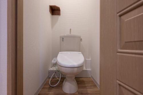 a bathroom with a white toilet in a room at HOTEL R9 The Yard Hitachinakaichige in Hitachinaka