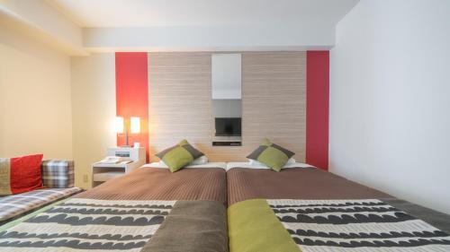 a bedroom with a large bed and a couch at New Otani Inn Sapporo in Sapporo