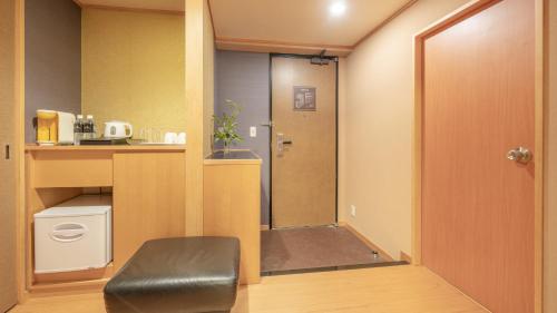 a small room with a door to a bathroom at New Otani Inn Sapporo in Sapporo