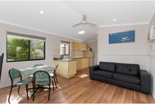 a living room with a couch and a table and chairs at Discovery Parks - Townsville in Townsville