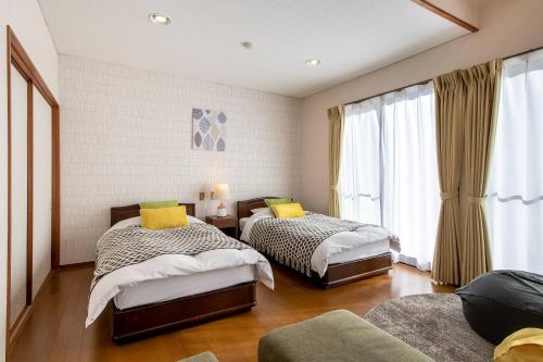 Postel nebo postele na pokoji v ubytování S-villa IZU Le-Nessa Akazawa -天然温泉&サウナ-